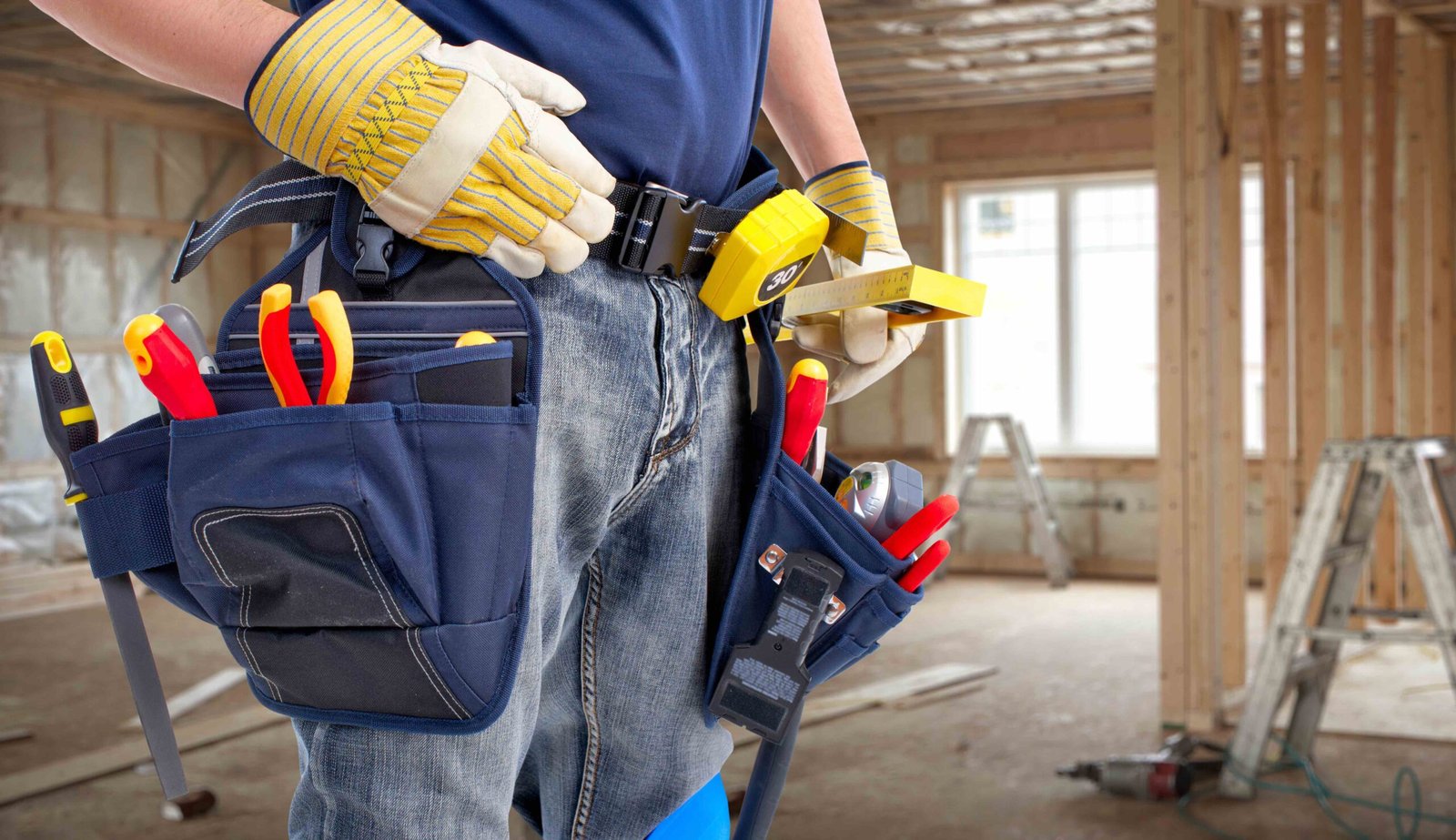 Worker with construction tools. House renovation background.