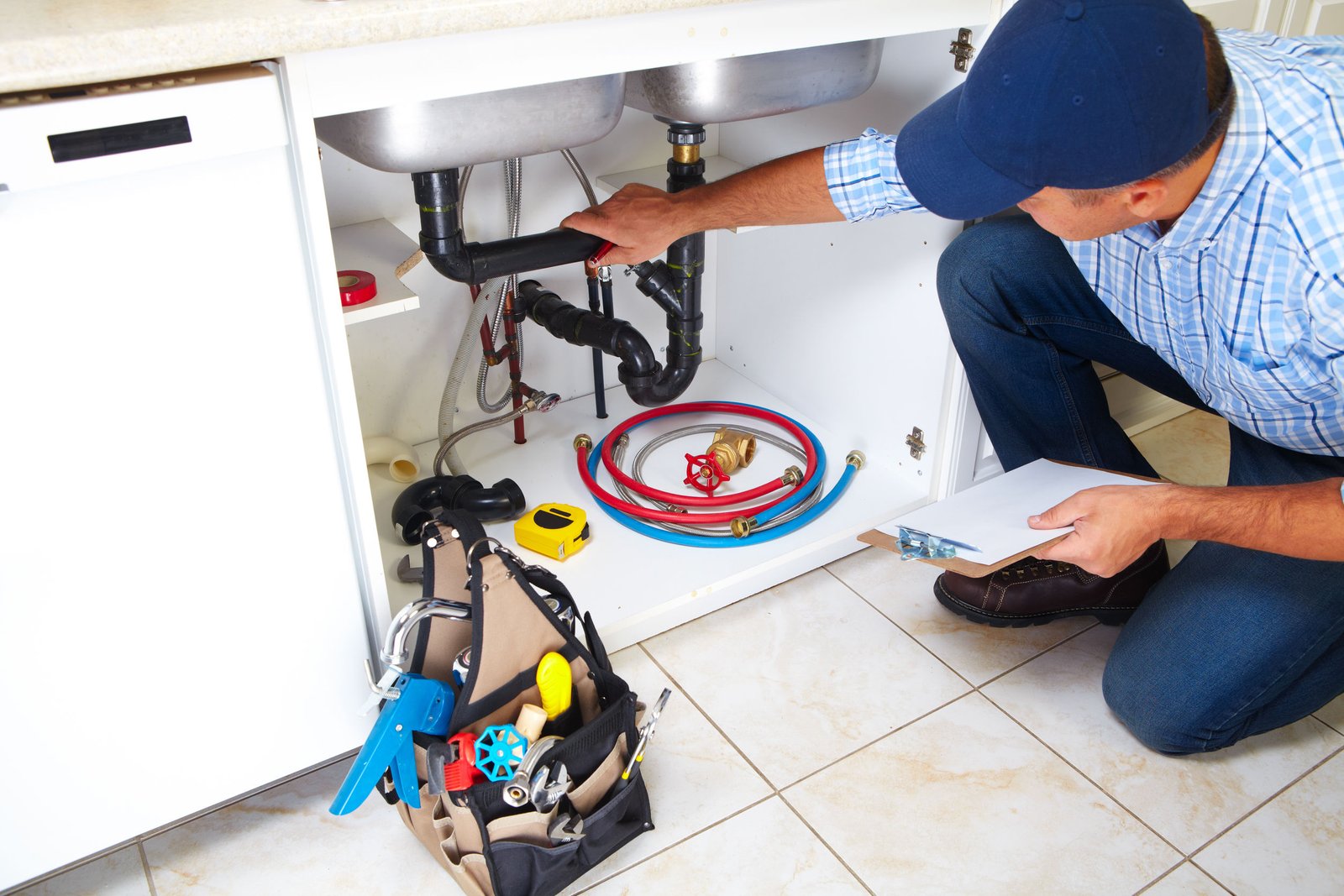 45779475 - plumber with plumbing tools on the kitchen. renovation.